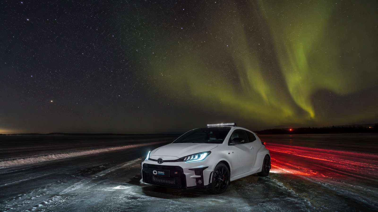 Zero Degrees GR Yaris parked on the ice under the northern lights
