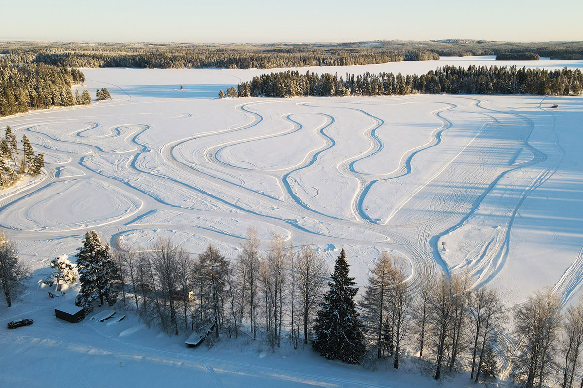 Aerial view of ice driving tracks carved into a frozen lake