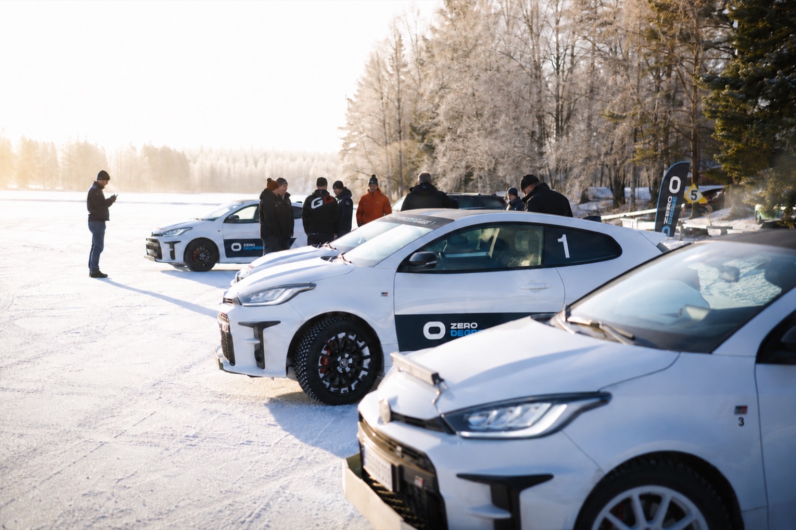 Guests gathered around the cars for the morning briefing